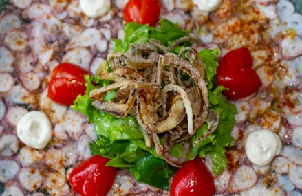 Carpaccio de pulpo, aceite de oliva y cítricos.